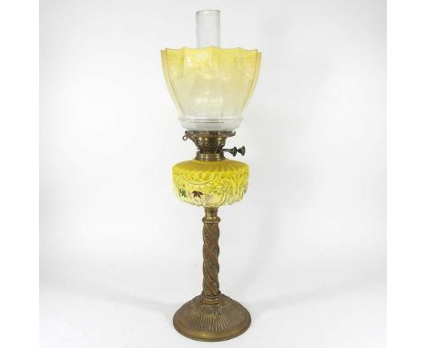 A Victorian brass oil lamp, having a twisted column and yellow opaque glass font, with an etched yellow glass shade, 60cm hig