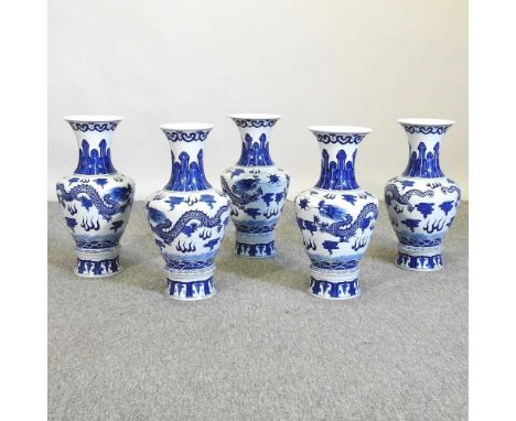 A garniture of five Chinese porcelain blue and white vases, 20th century, each decorated with a dragon, 41cm highCondition re