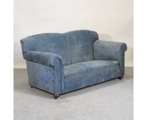 An early 20th century blue upholstered drop end sofa, on bun feet169w x 78d x 84h