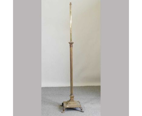 An early 20th century brass telescopic standard lamp, on paw feet