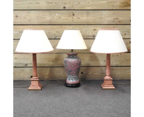 A pair of wooden column table lamps and shades, 60cm high overall, together with a Chinese pottery table lamp and shade (3)