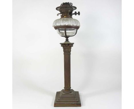 An early 20th century brass oil lamp, of column form, with a cut glass reservoir, 54cm high