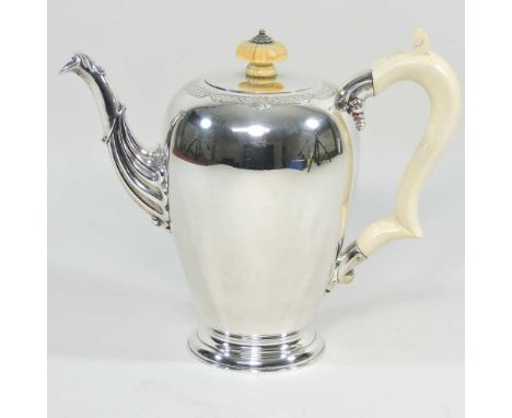 A mid 20th century silver coffee pot, of ovoid shape, with a scrolled spout and ivorine handle and finial, by Garrard &amp; C