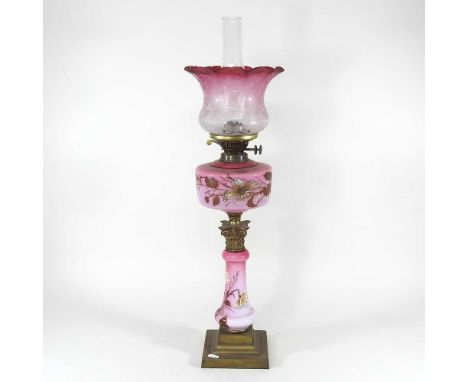A late 19th century pink opaline and brass oil lamp, in the form of a column, with an etched glass frilled shade, 66cm high o