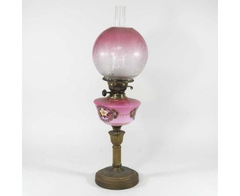 A late 19th century brass oil lamp, with a painted pink opaline font and etched glass shade, 57cm highCondition report: Dirty