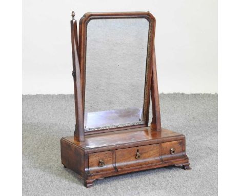 A 19th century walnut swing frame toiletry mirror, containing three cavetto moulded short drawers, on bracket feet, 36cm