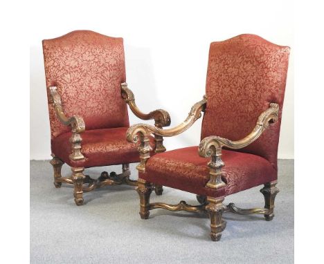 A pair of large continental red upholstered throne chairs, 20th century, with gilt scrolled arms, on carved supports75w x 90d