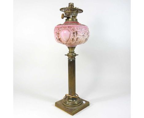 A mid 20th century brass column table lamp base, with a pink opaline glass reservoir, 54cm highCondition report: Generally di