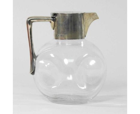 A Victorian silver mounted glass claret jug, in the manner of Dr Christopher Dresser (1834-1904) of dimpled form, with a hing