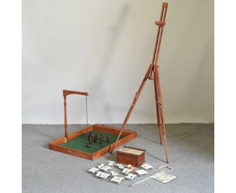 A Jacques wooden skittles game, 92cm long, together with a clockwork golf game and a wooden artist's easel (3)