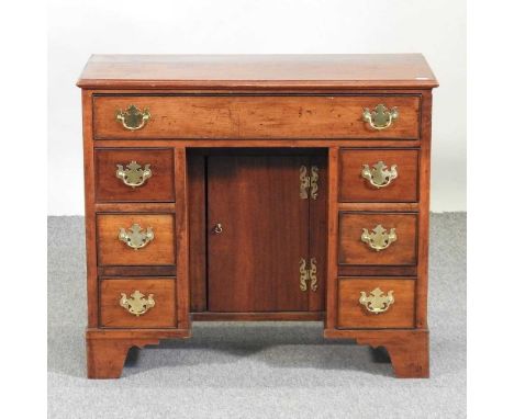 An unusually small George III style kneehole desk, 20th century, containing seven short drawers, on bracket feet, 79cmConditi