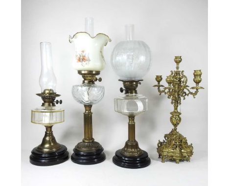 An early 20th century Duplex oil lamp, with an etched glass shade, 55cm high overall, together with two others and an ornate 