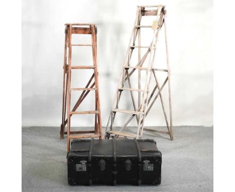 An antique wooden step ladder, together with another similar and a cane bound trunk, 89cm wide (3)