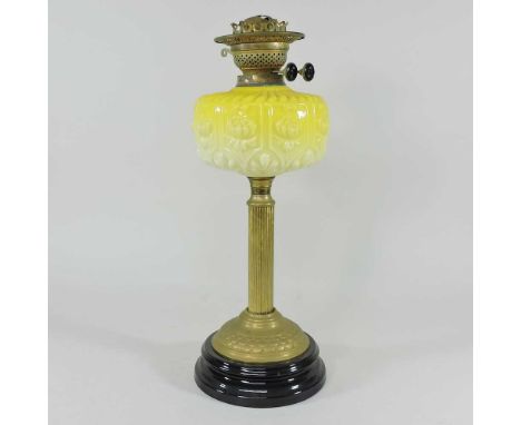An early 20th century brass oil lamp, with a yellow opaque glass font, on a pottery base, 48cm highCondition report: Dirty. M