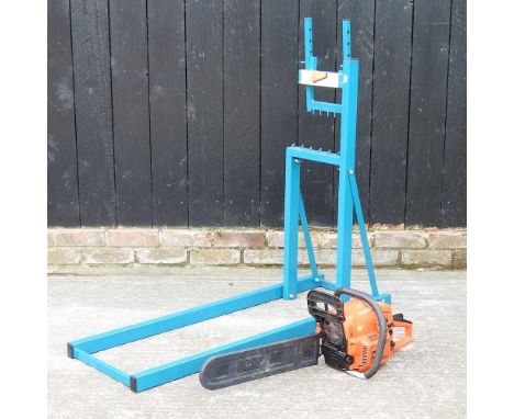 A BMC petrol chainsaw, together with a Makita saw horse (2)