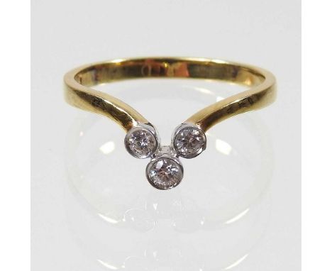 An 18 carat gold three stone diamond ring, 2.5g, size M/N