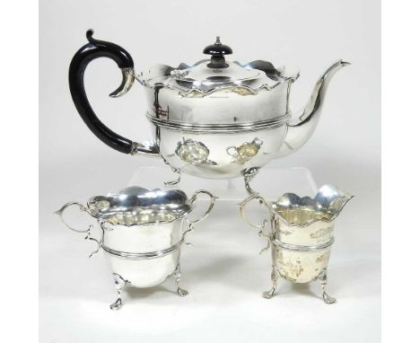 An early 20th century matched silver three piece tea service, comprising a teapot, of circular form, Birmingham 1931 and a si