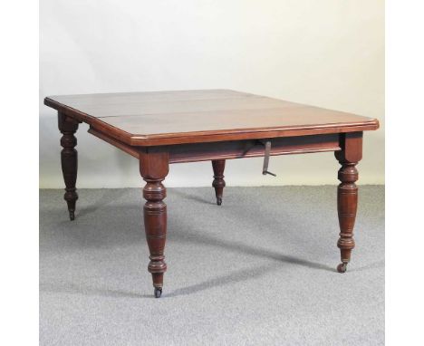 A late Victorian walnut wind out extending dining table, with additional leaf, on turned legs, with winding handle181w x 119d