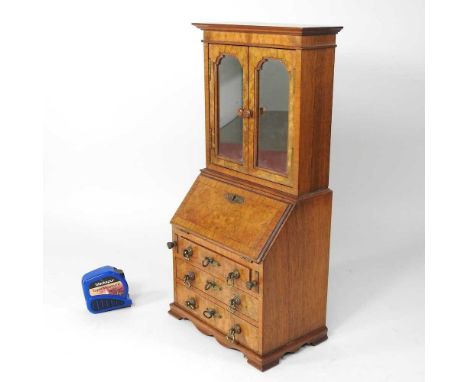 A George I style walnut apprentice bureau cabinet, 20th century, with a fitted interior, on bracket feet, 18cm wide18w x 11d 