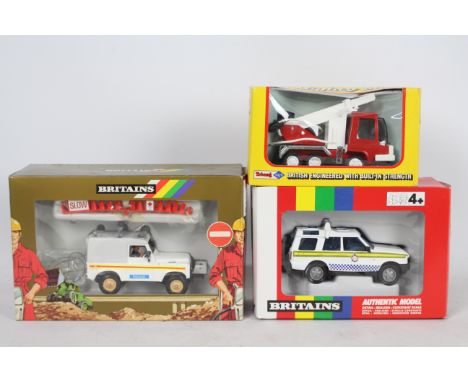 Britains, Triang - Three boxed diecast and tinplate models in various scales. Lot consists of Britains 9917 Police Land Rover