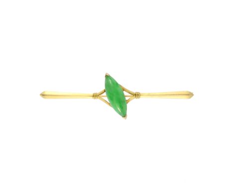 An antique Chinese jade brooch in high carat yellow gold set with a central marquise shaped jade cabochon set at an angle to 