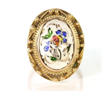 An antique Victorian enamel ring in 15ct yellow gold set with an oval enamelled panel featuring a floral motif. Ring size 4 /