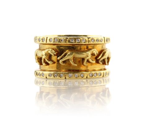 A vintage Cartier style jewelled diamond panther ring in 18ct yellow gold designed as a heavy gold band featuring five high r