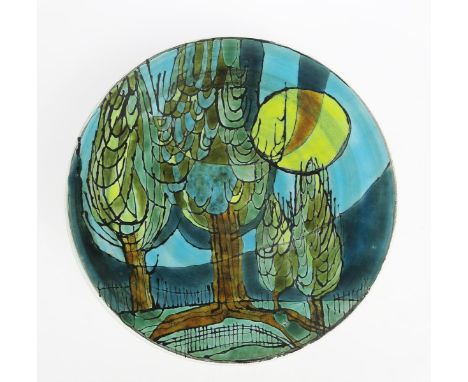 A Poole Pottery Studio Pollarded Willow charger by Tony Morris,  painted with semi-abstract trees before a moonlight sky, in 