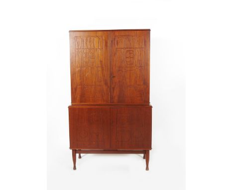 A Scandinavian teak cabinet in the manner of Stig Lindberg,  the twin-cupboard with fitted shelves and two narrow drawers, ab