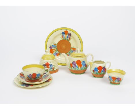 'Crocus' a Clarice Cliff part tea set, painted in colours, comprising; teapot and cover, milk-jug and sugar basin, one cup, s