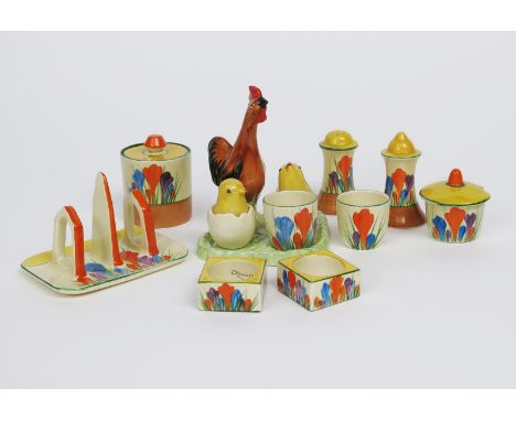 'Crocus' a Clarice Cliff two slice toast rack, painted in colours, and  a Hen and Chick cruet set comprising modelled tray, s