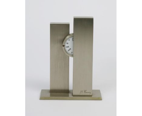 A Modernist brushed steel mantel clock by Michel Fleury,  two rectangular columns supporting rotating dial face, with Roman n