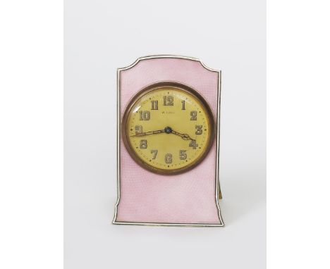 A Continental silver and enamel easel backed travel clock, shaped rectangular panel with guilloche enamel, circular dial with