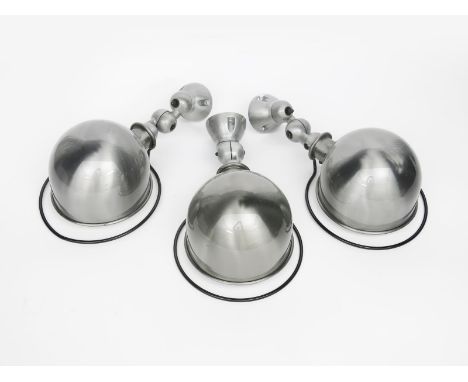 Three Jielde polished brushed steel  wall lamps designed by Jean-Louis Dormecq,  the domed shades with articulated stems, uns