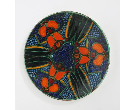 A modern Poole Pottery Studio charger by Tony Morris, dated 1999, painted with radiating dragonfly in orange, red, turquoise 
