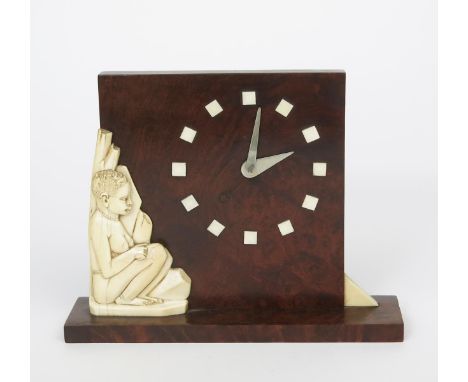 ‡ An Art Deco burr wood and ivory mantel clock, the square body set with carved ivory figure, the dial with square hours, pol