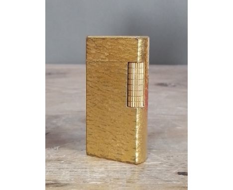 A vintage Dunhill gold plated textured lighter.  