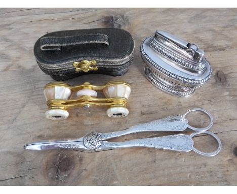 A mixed lot comprising a pair of silver plated grape scissors, a Ronson Queen Anne table lighter and a pair of Lemaire opera 