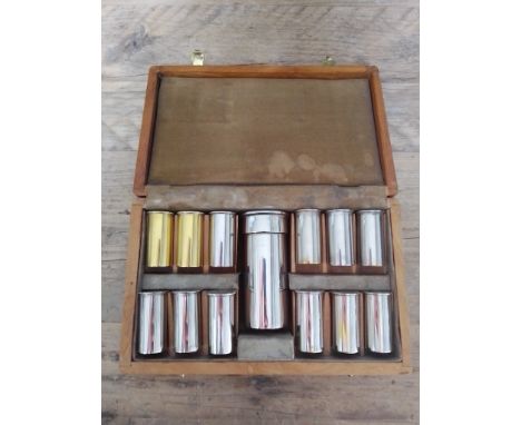 A silver plated novelty cased drinking set comprising flask and 12 shot glasses modelled as shotgun cartridges.  