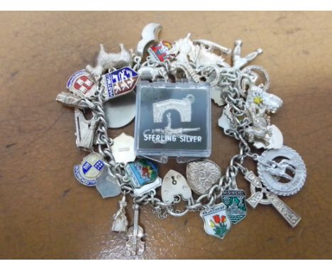 A vintage silver charm bracelet, with two spare charms, gross wt. 70.2g. 