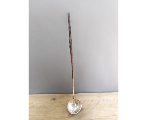 A 19th century twist baleen and white metal punch ladle, length 38cm.  Condition - metal in our opinion is likely silver but 