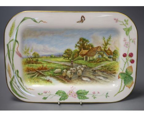 A rectangular dish with rounded corners painted with painted with sheep, a man and dog and a country house by Francis Clark, 