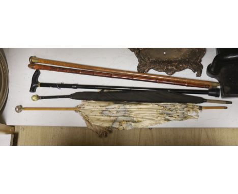 A Chinese bamboo walking stick, two parasols and another stick