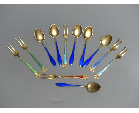 Six Norwegian sterling gilt and enamel small forks and six sterling and blue enamel coffee spoons.