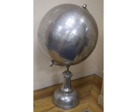 A large polished metal stylised celestial globe, retailed by Andrew Martin, H approx 110cm