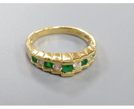 An Art Deco style emerald and diamond nine-stone ring in stepped setting, stamped 14K, size K, gross 3.5 grams.