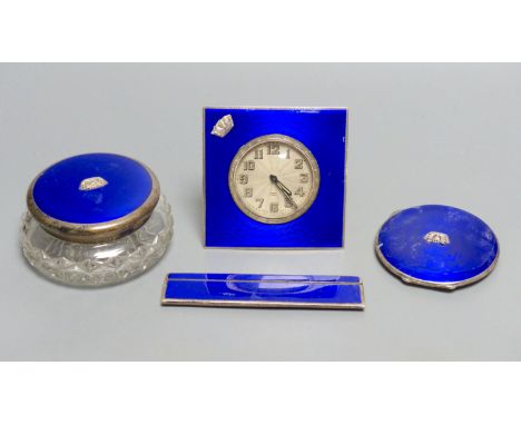 A 1930's four piece silver and blue enamel dressing table set, including , timepiece, powder jar, compact &amp; comb, Birming