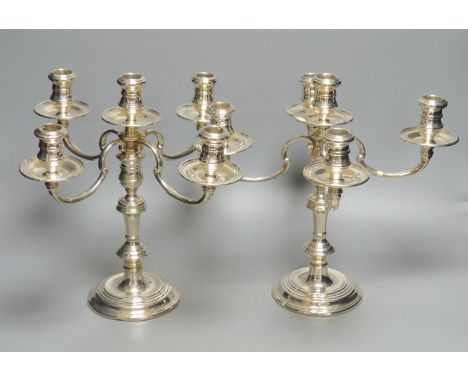 A pair of Georgian style silver four-branch five-light candelabra, Makers William Comyns &amp; Sons Ltd, London 1967 (weighte