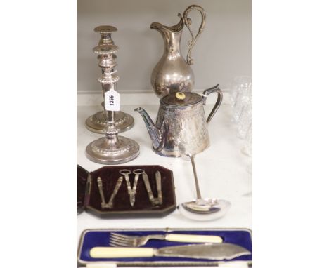 A pair of plated candlesticks, a wine ewer, height 33cm (dented), teapot, ladle, cased nutcrackers