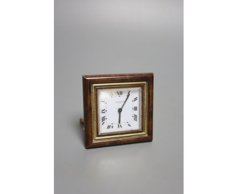 A gilt metal and faux tortoiseshell mounted Cartier travelling clock, with red Cartier pouch (small chips to border).